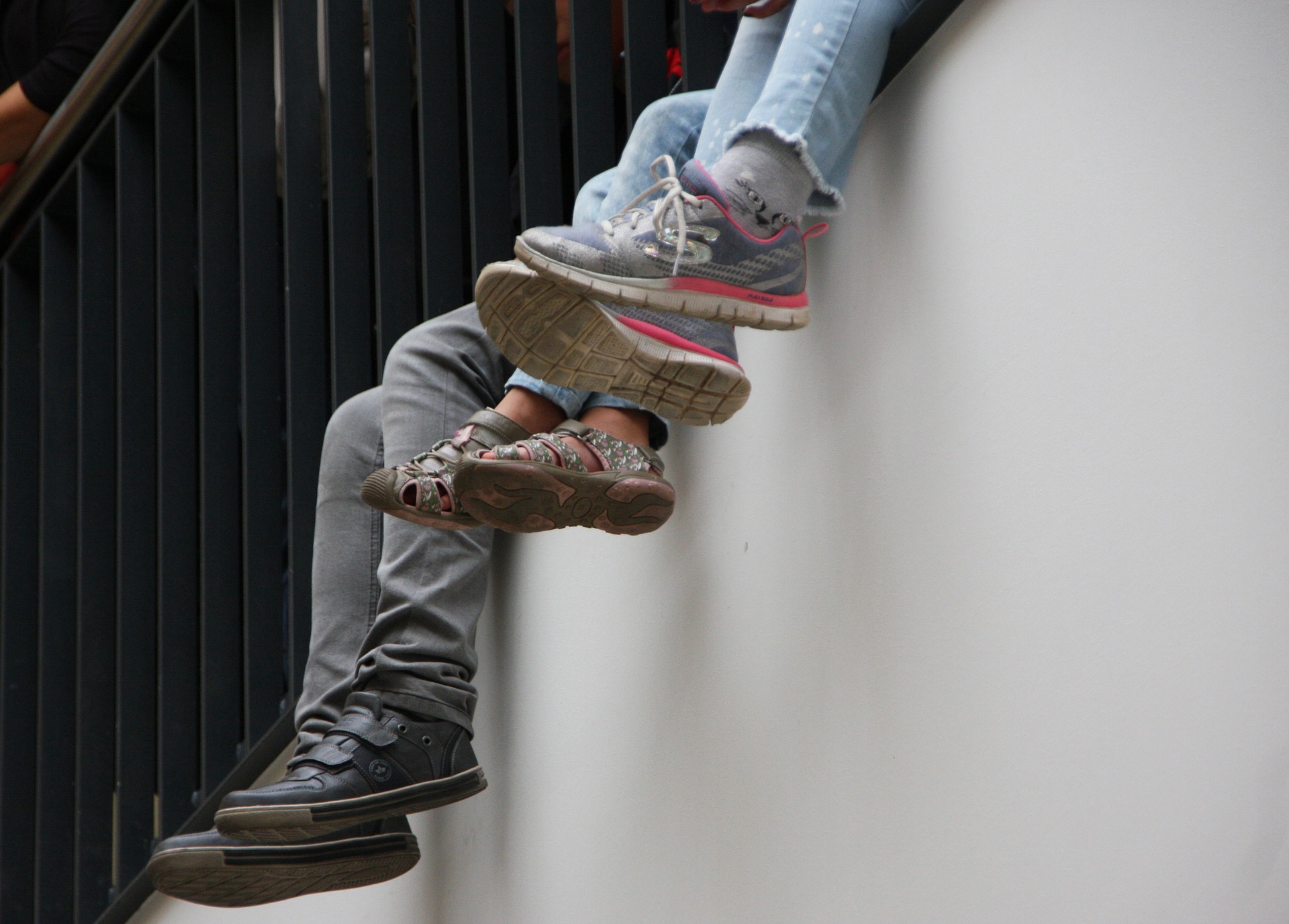 legs dangling off a wall